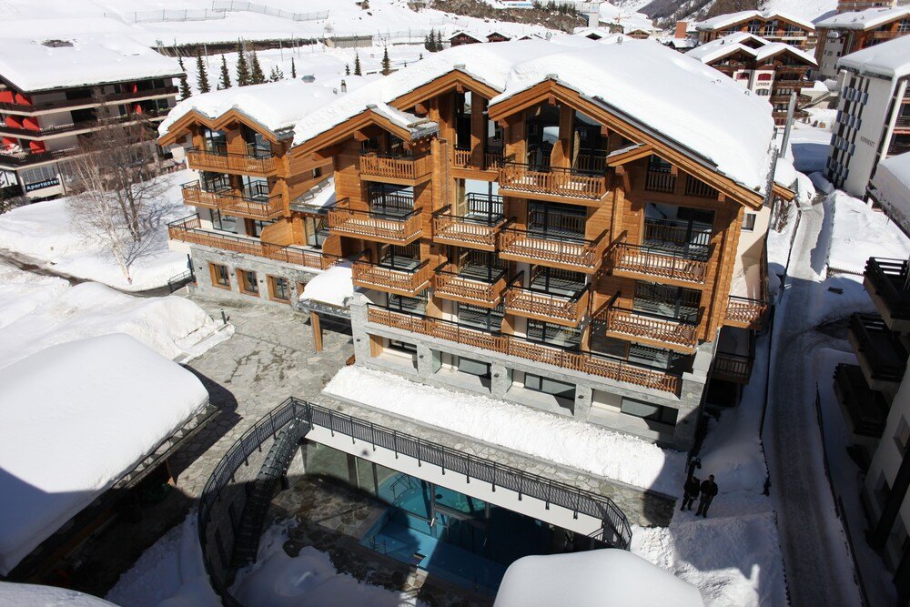 Multi-story wooden hotel building with balconies in Zermatt