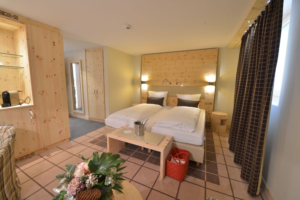 Hotel room with wooden details and a cozy alpine feel