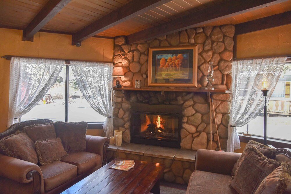 Cozy room with a wood stove at Alpine Lodge