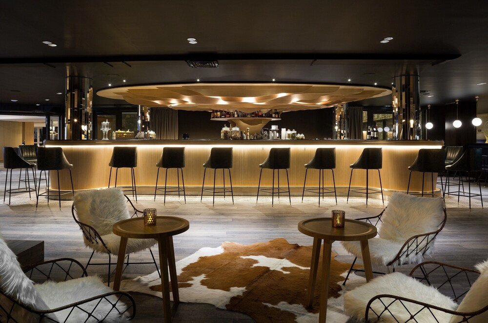 Bar area with a circular counter and stools at the hotel