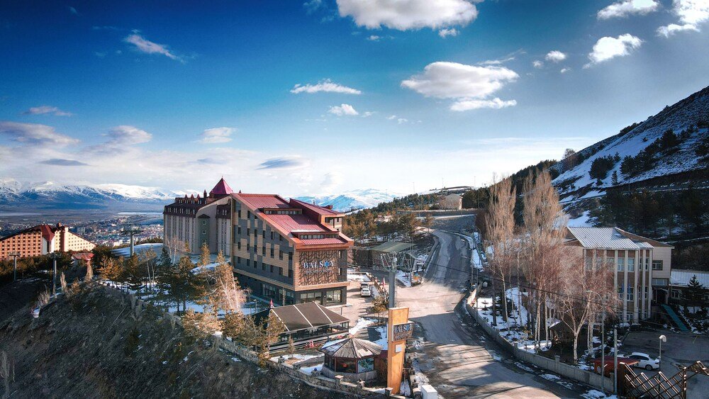 Hotel with a red roof set against the mountain