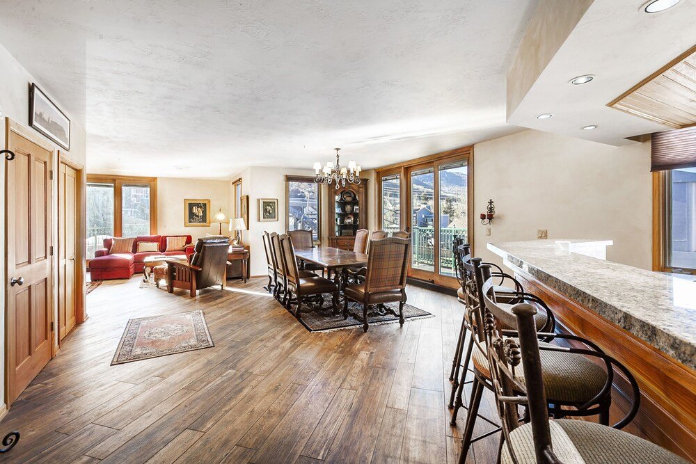 Spacious dining area with table and chairs in a condo unit