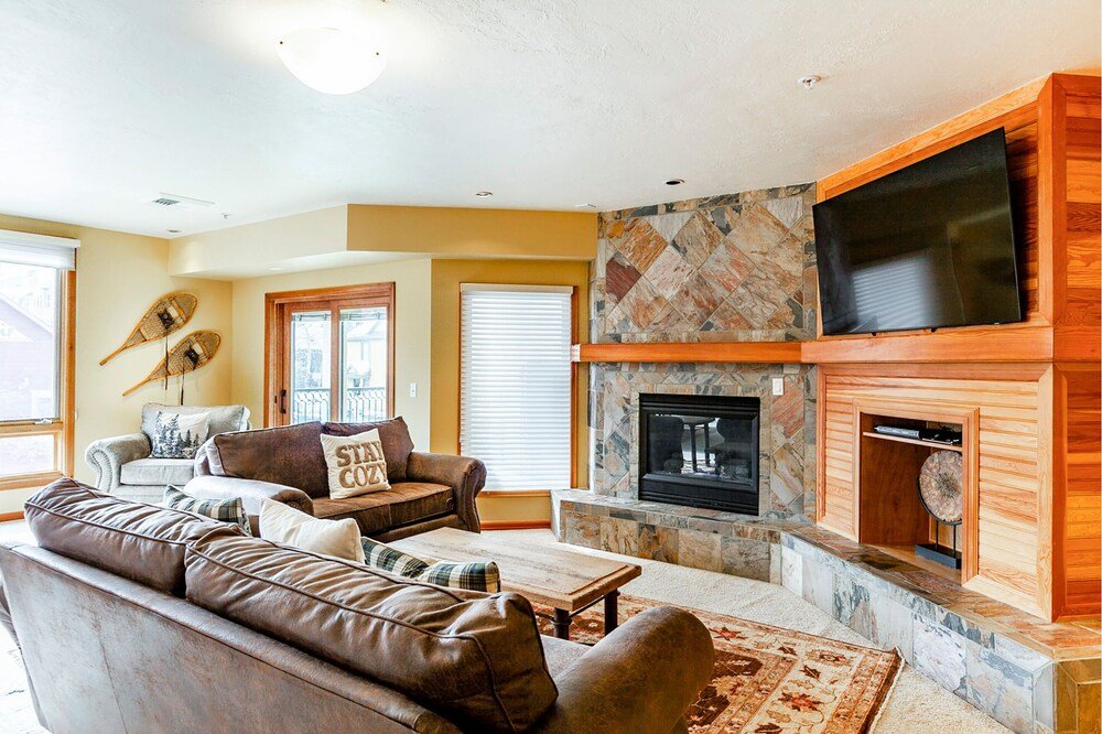 Living room with a fireplace in a Caledonian unit