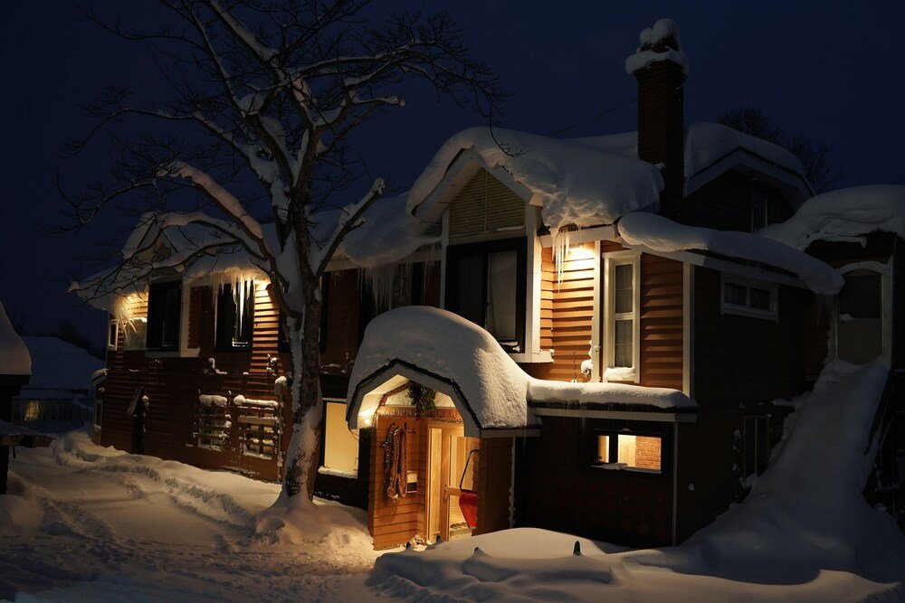 Snow-covered house with a wooden exterior