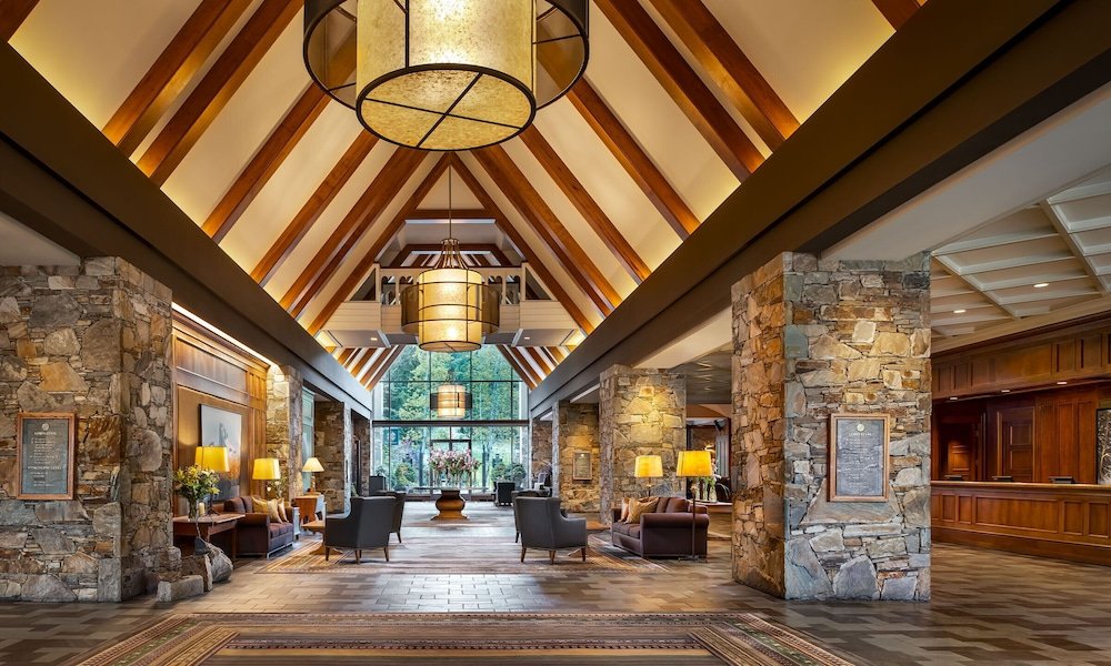 Spacious lobby with stone walls at Fairmont Chateau Whistler