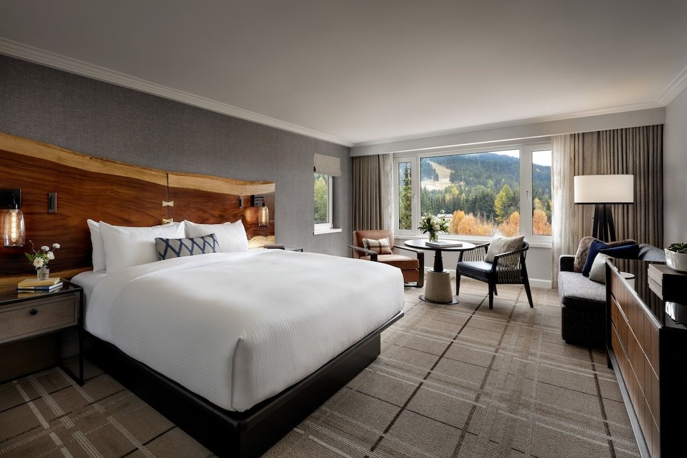 Hotel room with a large bed at Fairmont Chateau Whistler