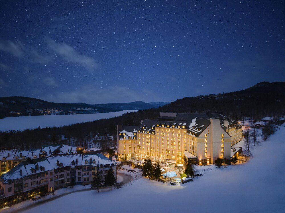Snow-covered Fairmont Tremblant hotel exterior in winter