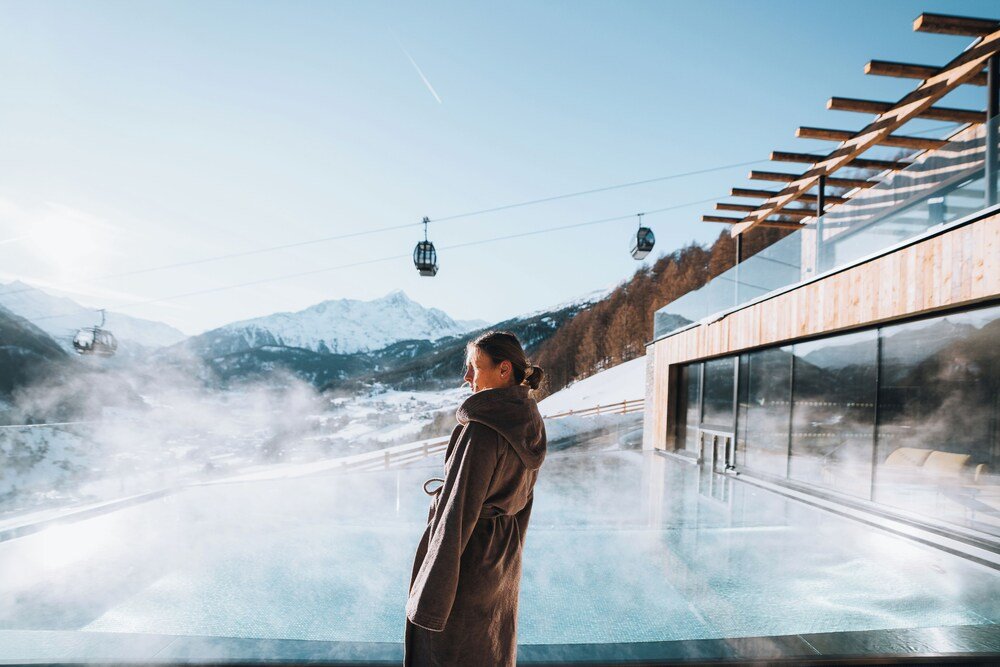 Guest looking out of a window with a mountain view
