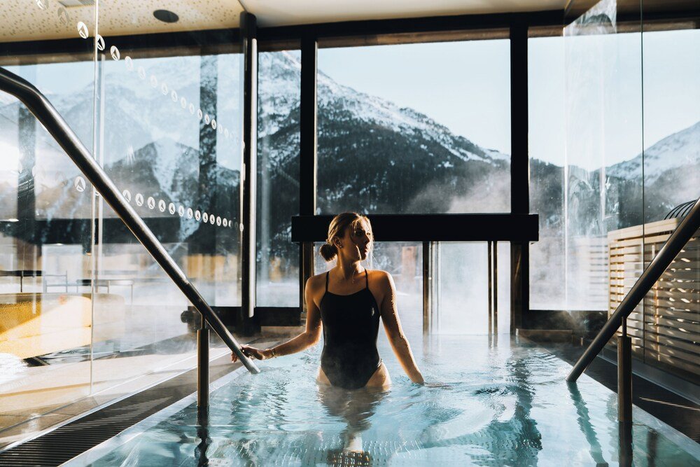 Swimming pool inside the hotel with loungers