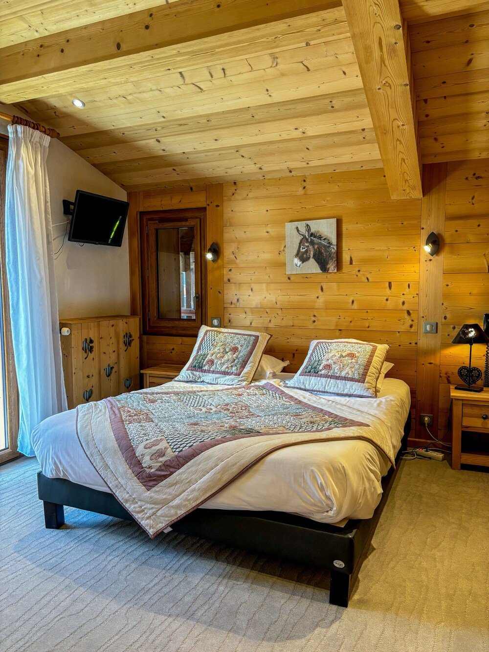 Wood-panelled bedroom with a comfortable bed