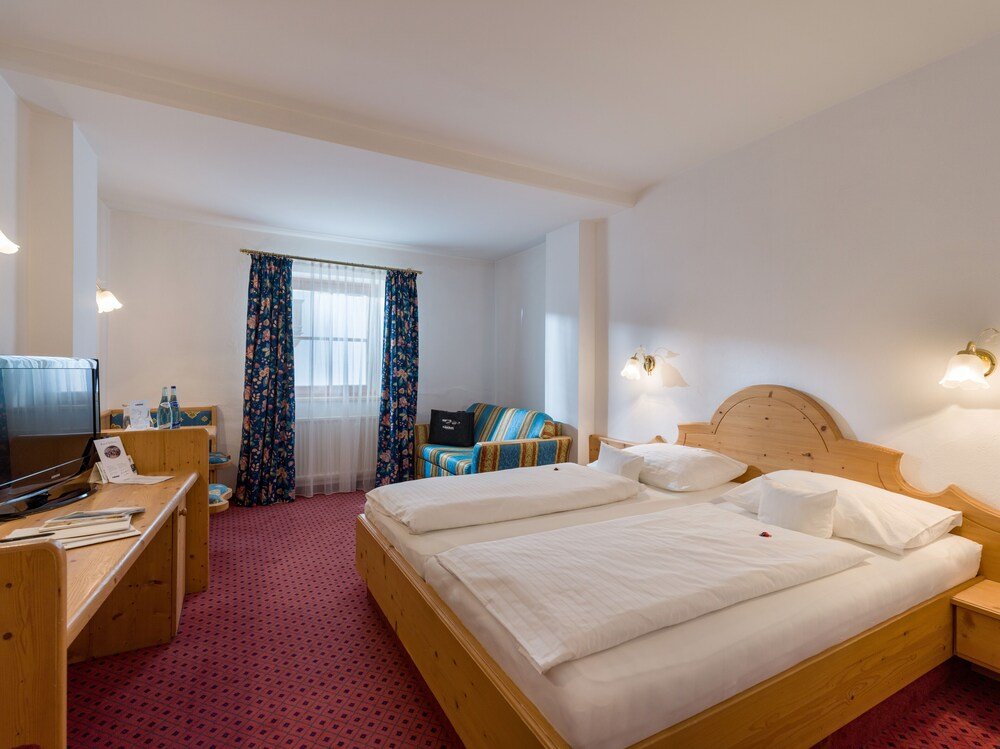Hotel room with a wooden bed and a desk