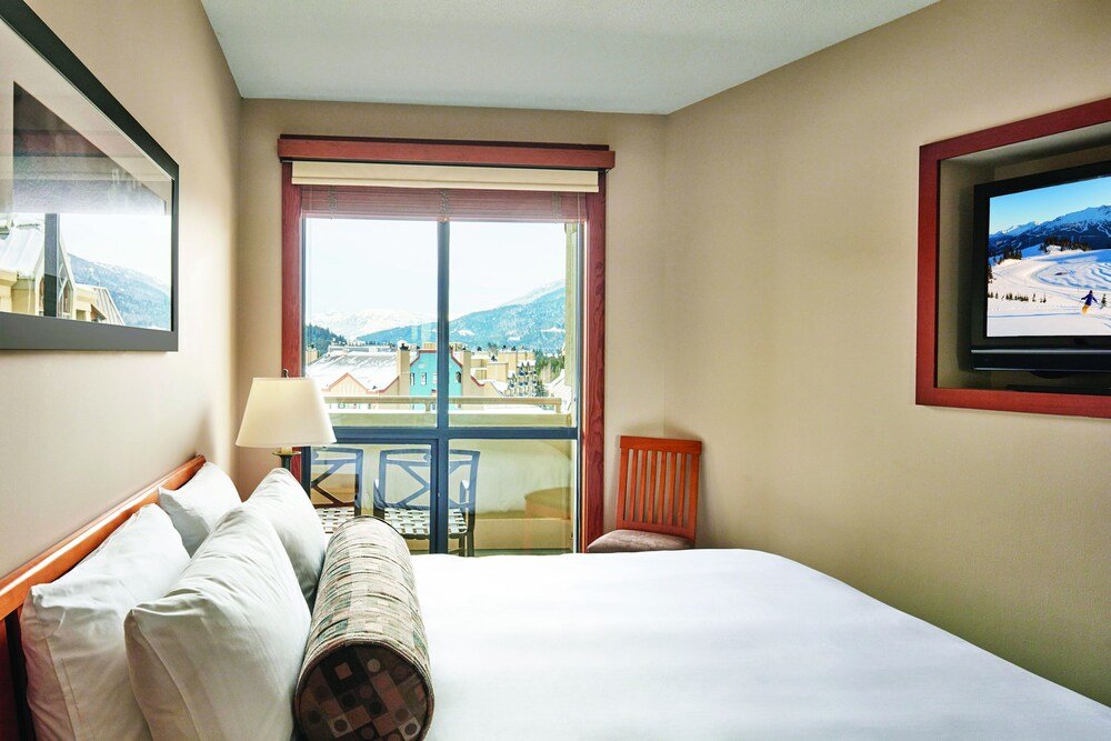 Hotel room with a large bed at Pan Pacific Whistler Mountainside