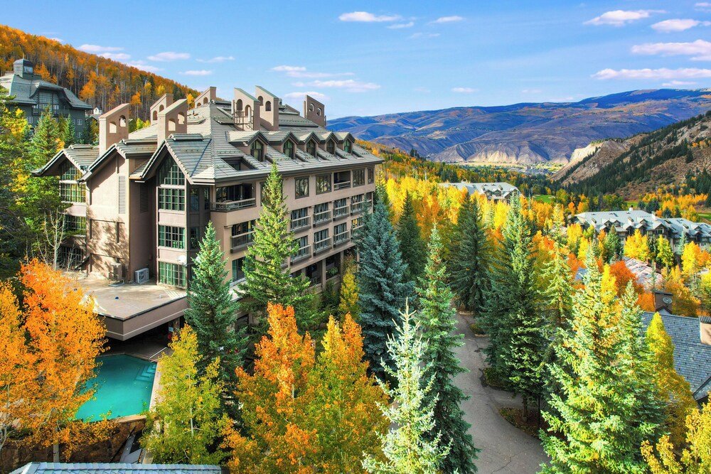 Large mountain lodge building with timber and stone exterior