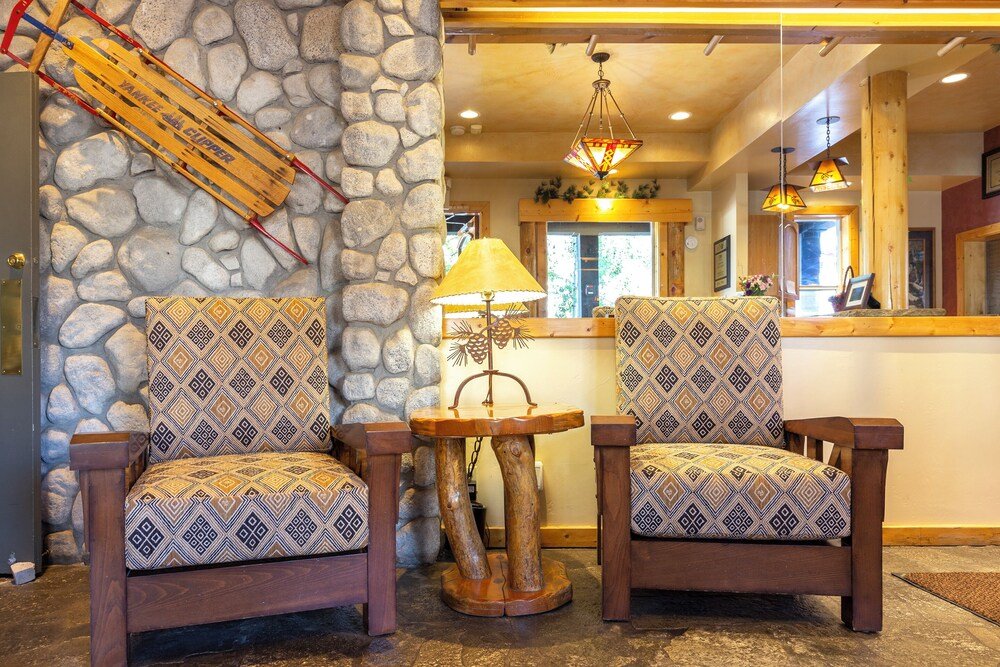 Wooden chairs in a common area at Red Wolf Lodge