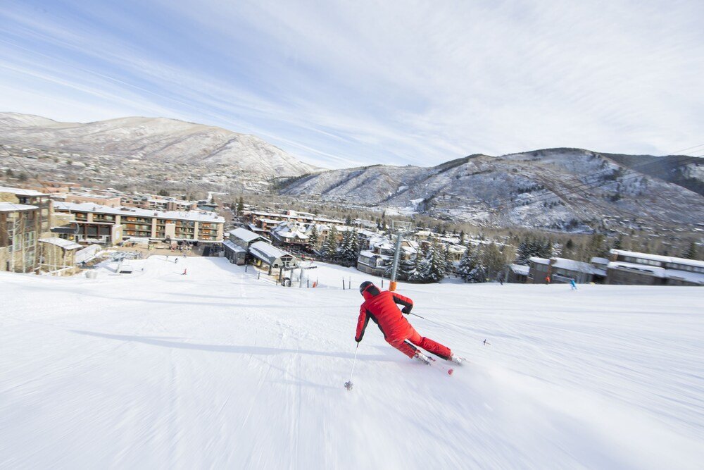 Skier on a snowy ski slope in the mountains near Aspen