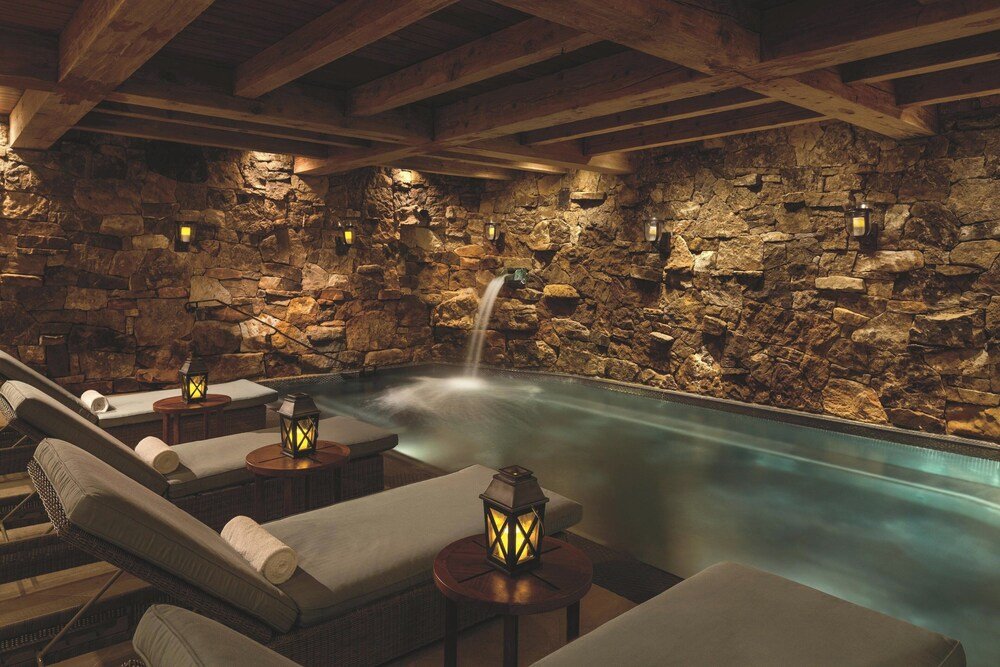 Spa area with a stone wall at The Ritz-Carlton Bachelor Gulch