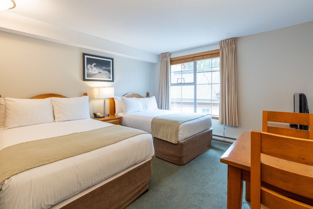 Hotel room with two beds at Sundance Lodge in Sun Peaks