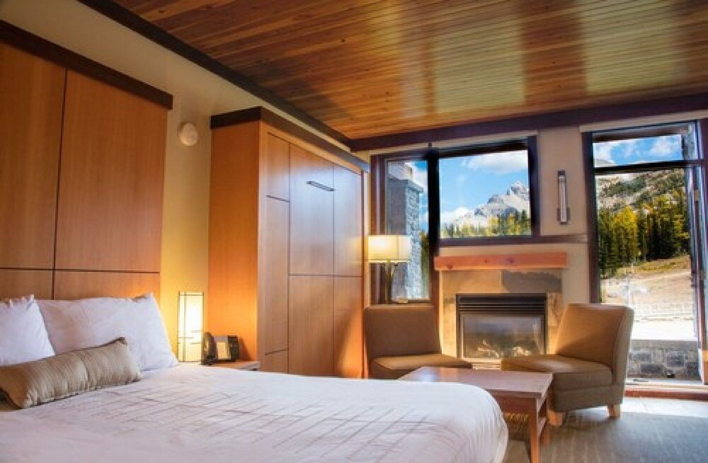 Hotel room with a large bed and wooden cabinets
