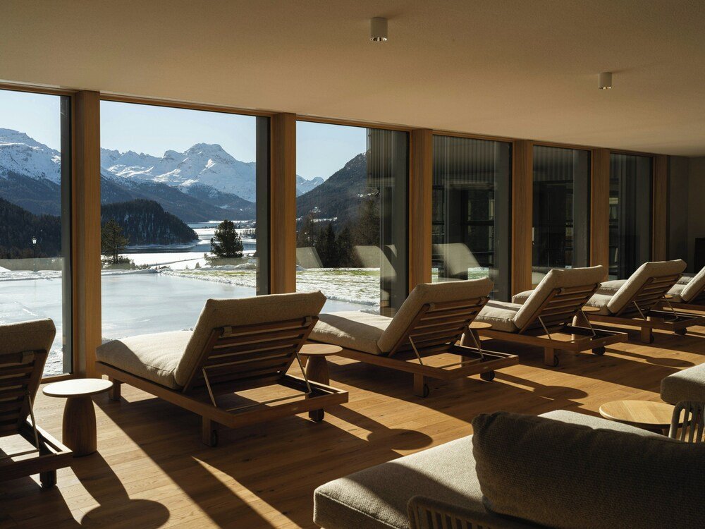 Room with large windows and a mountain view