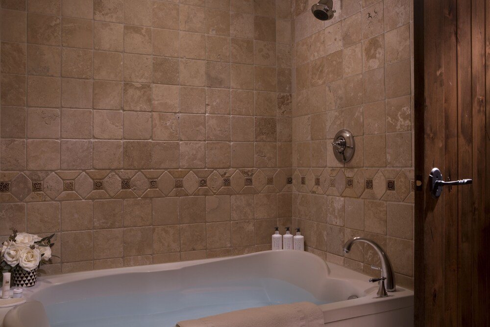 Lodge bathroom with a bathtub at Teton Mountain Lodge