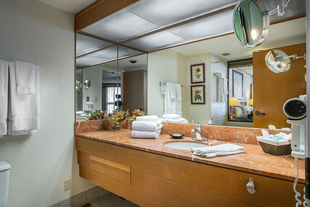 Bathroom with a marble vanity and large mirror