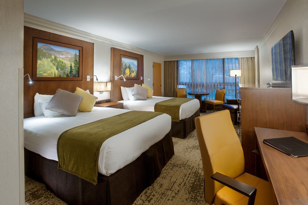 Hotel room with two beds and a desk