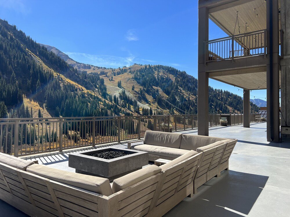 Balcony with a built-in fire pit and seating area