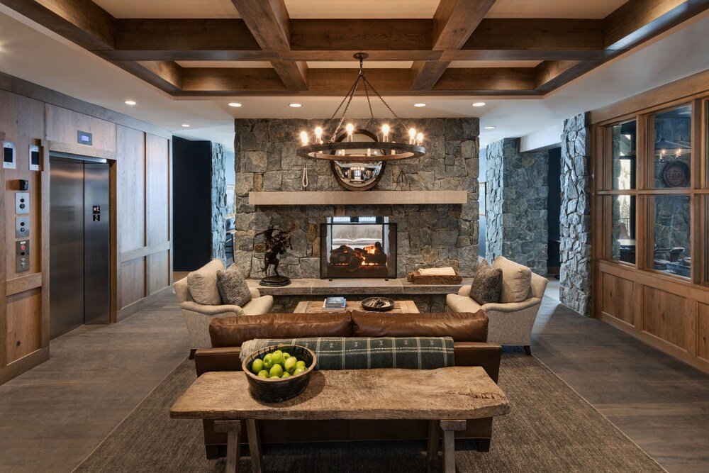Spacious living area with a stone fireplace