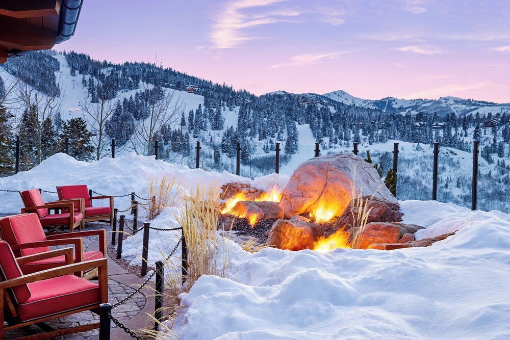 Snow-covered outdoor seating area with a fire pit