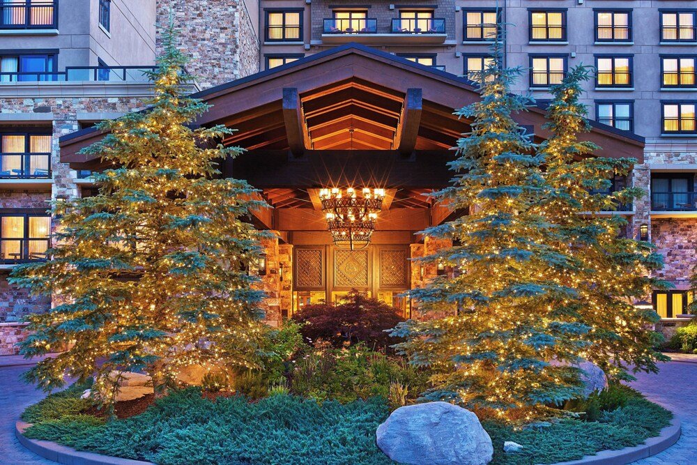 Hotel entrance with covered walkway and stone facade