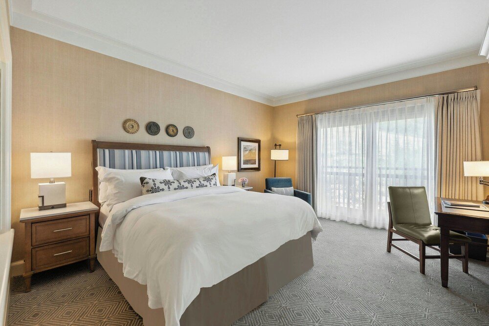 Hotel room with a large bed and a window