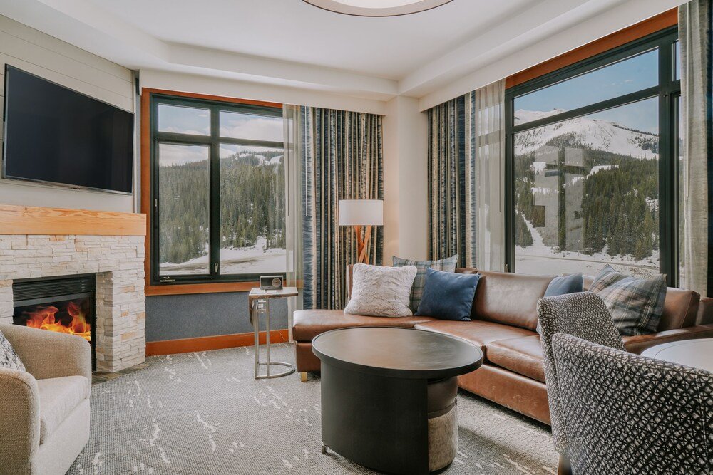 Modern living room with a fireplace and large windows
