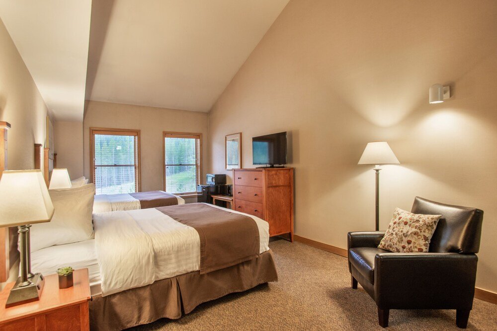 Guest room with a made bed and a window